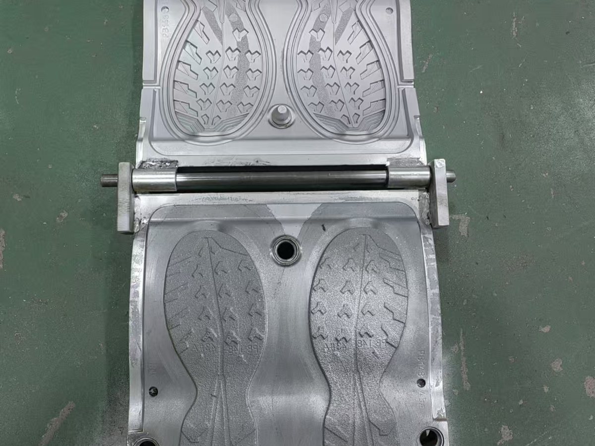Open two-cavity metal outsole mould with the tread pattern machined into both halves