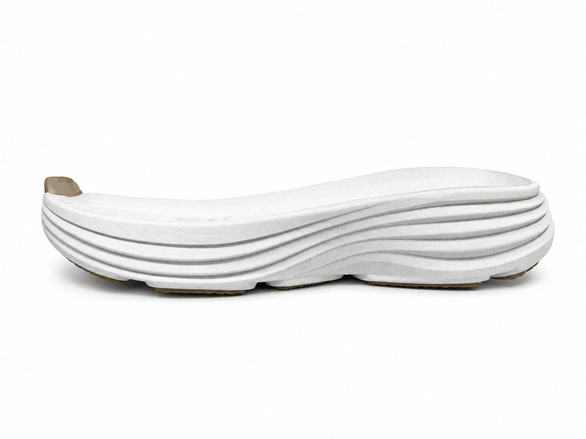 White layered midsole seen from the side, with stacked ripples along its length
