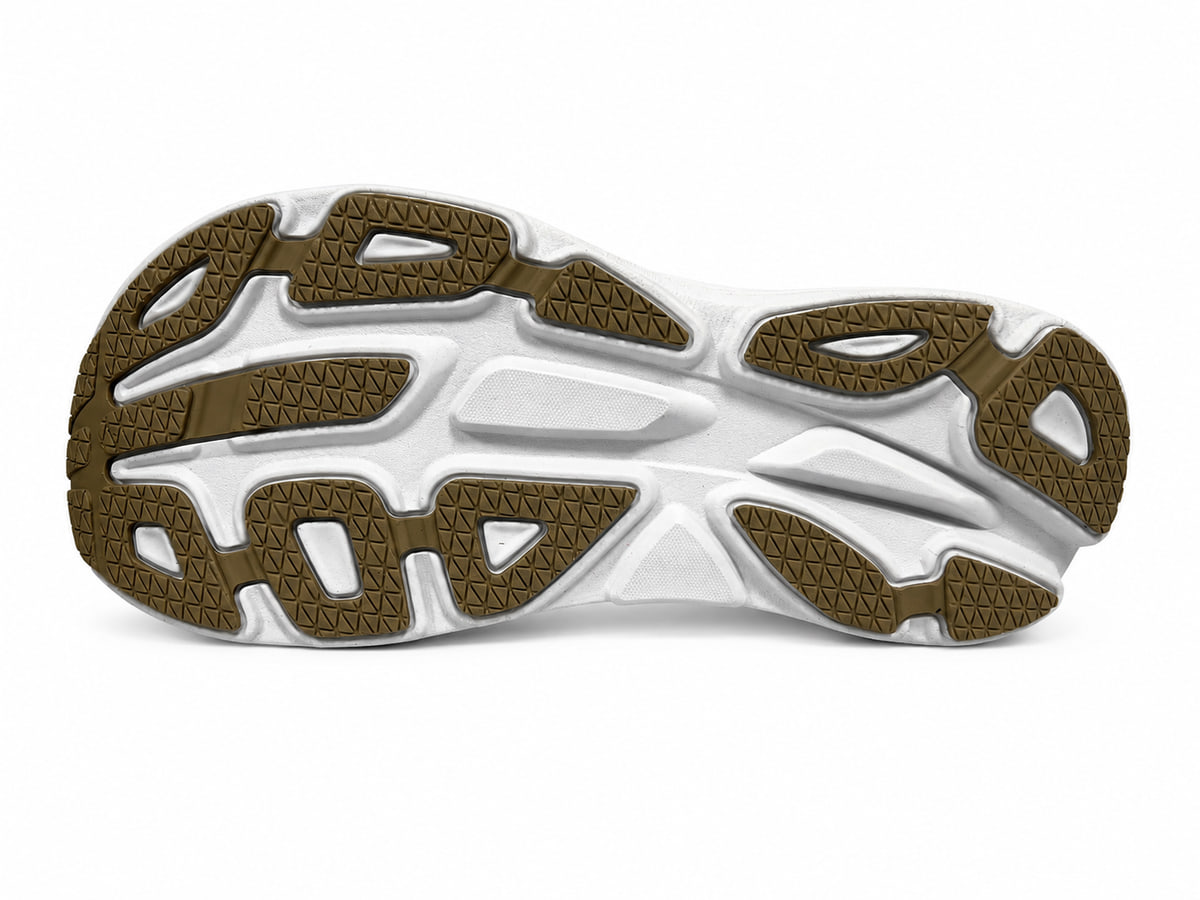 Underside of the same white sole, with olive-brown rubber pads in a fine triangular grip pattern over a sculpted white midsole