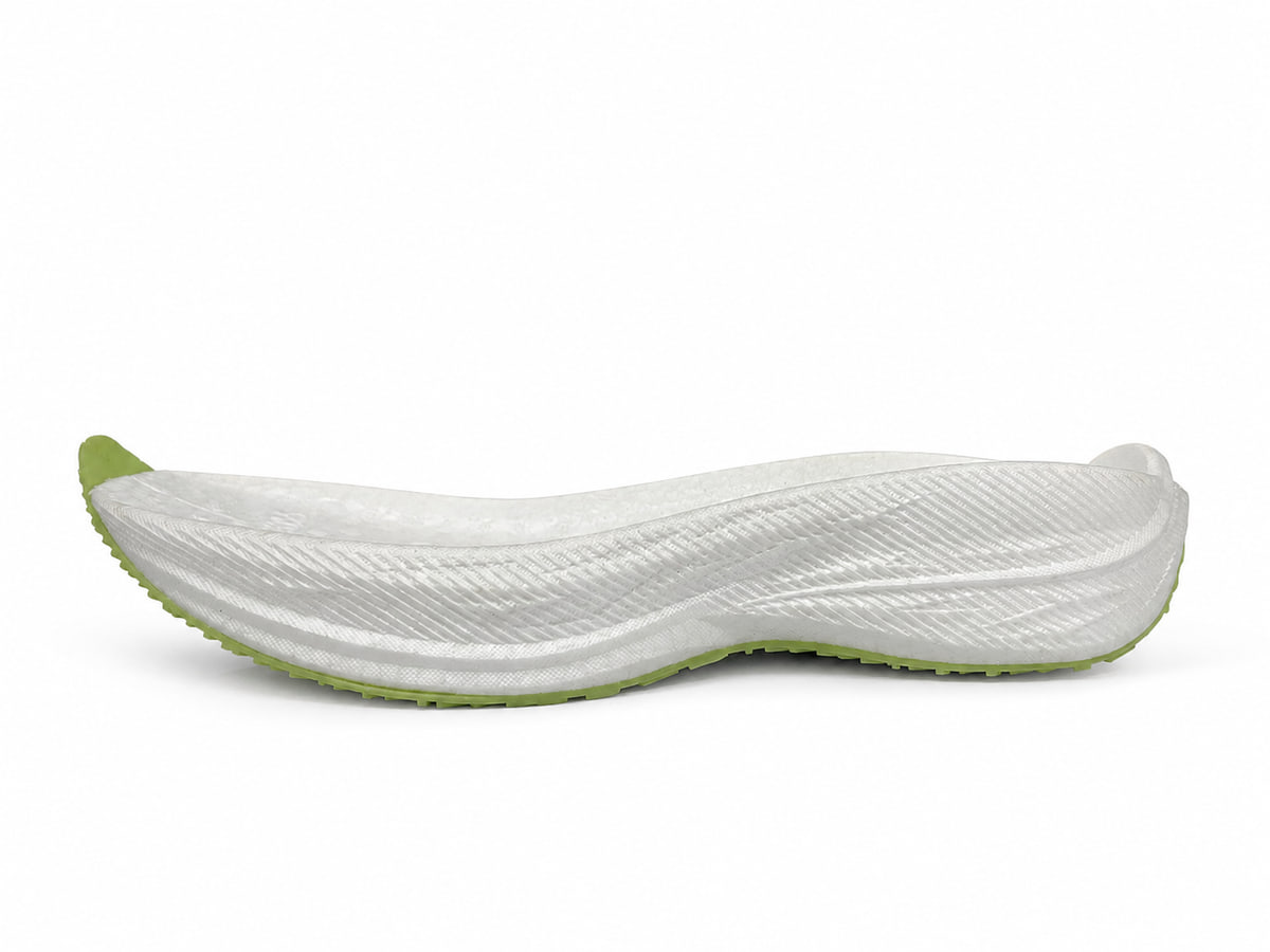 White foamed midsole with a green outsole, seen from the side