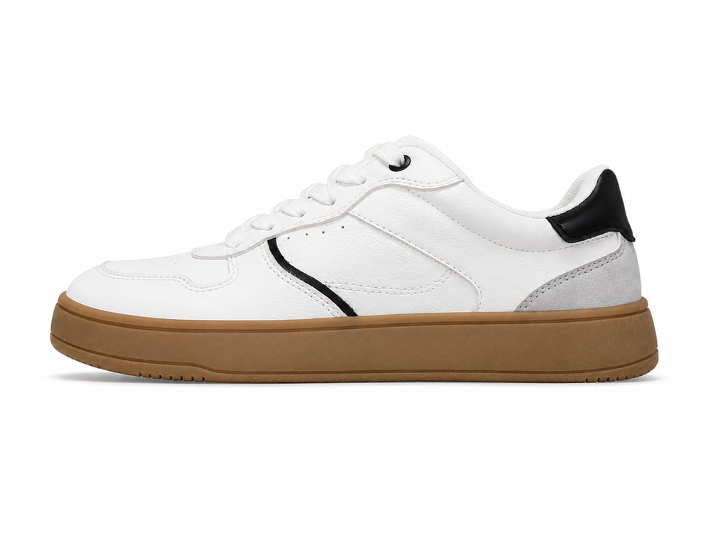 White leather comfort sneaker on a roomy rounded last with perforated vamp and a gum outsole, developed to customer drawings by DOING Footwear